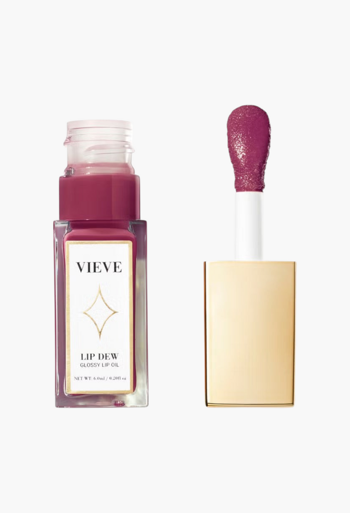 GLAM MODA VIEVE Lip Dew glossy lip oil in a deep berry shade with a gold applicator cap and clear glass bottle.