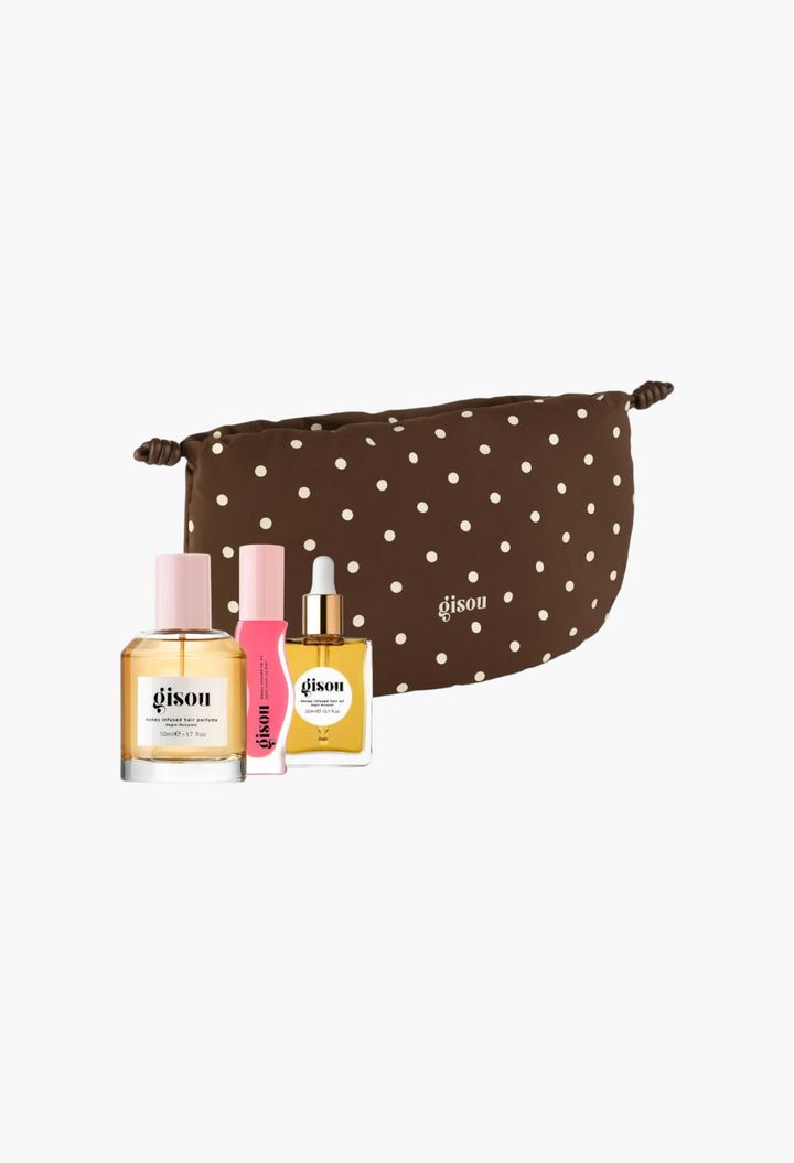 GLAM MODA Gisou Honey Glow-Getter Set featuring hair perfume, hair oil, and lip oil in a brown polka dot pouch.