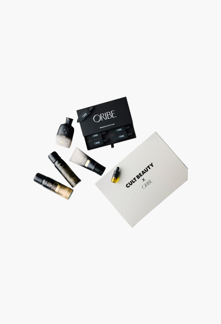 GLAM MODA Cult Beauty X Oribe haircare set featuring travel-sized shampoo, conditioner, sprays, oil, and hair clips.