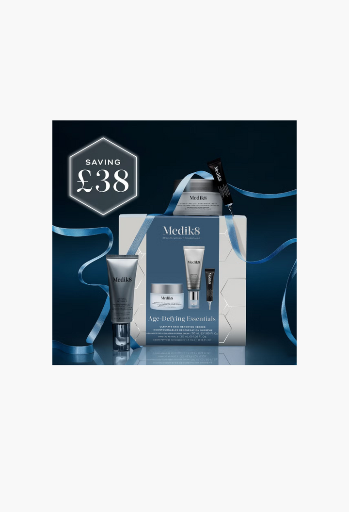 GLAM MODA Medik8 Age-Defying Essentials skincare gift set featuring anti-aging cream, retinal serum, and peptide serum.