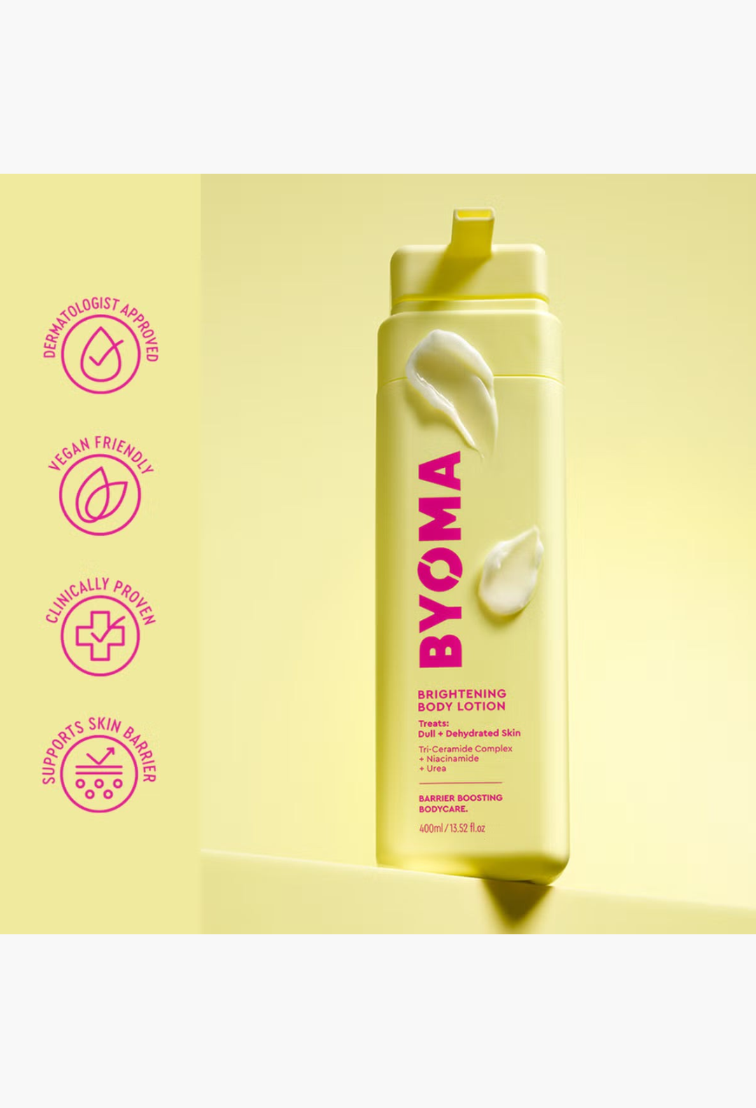 GLAM MODA BYOMA Brightening Body Lotion in a yellow bottle with pink text and cream dollops on a yellow background.