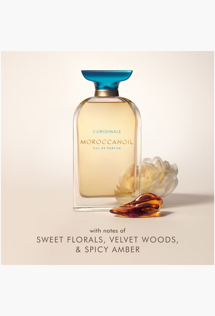 GLAM MODA Moroccanoil L'Originale Eau de Parfum bottle with a blue cap, featuring floral and amber accents.