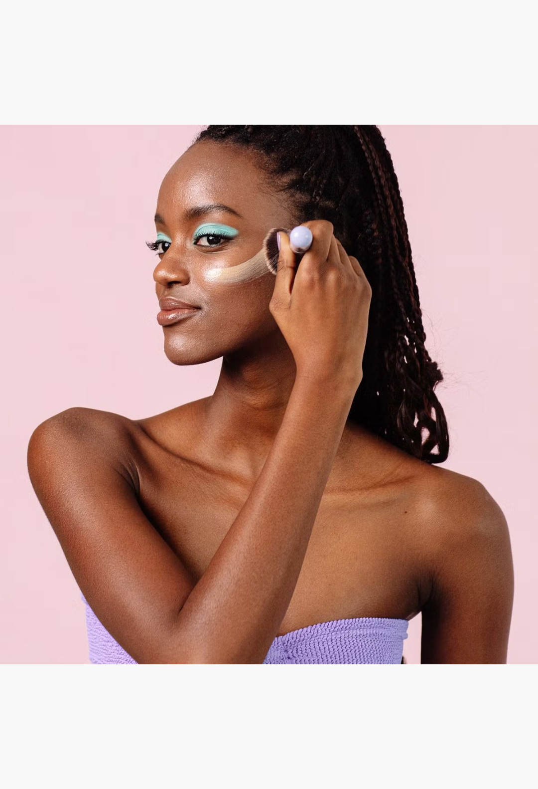 GLAM MODA model applying Naked Sundays Cabana Glow SPF50 illuminating serum drops with a makeup brush on her cheek
