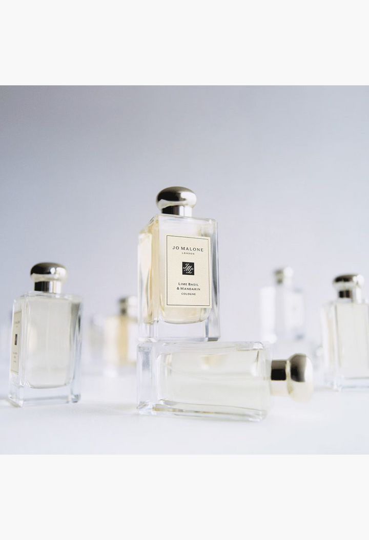 GLAM MODA Jo Malone London cologne bottles arranged on a white surface with a minimalist aesthetic