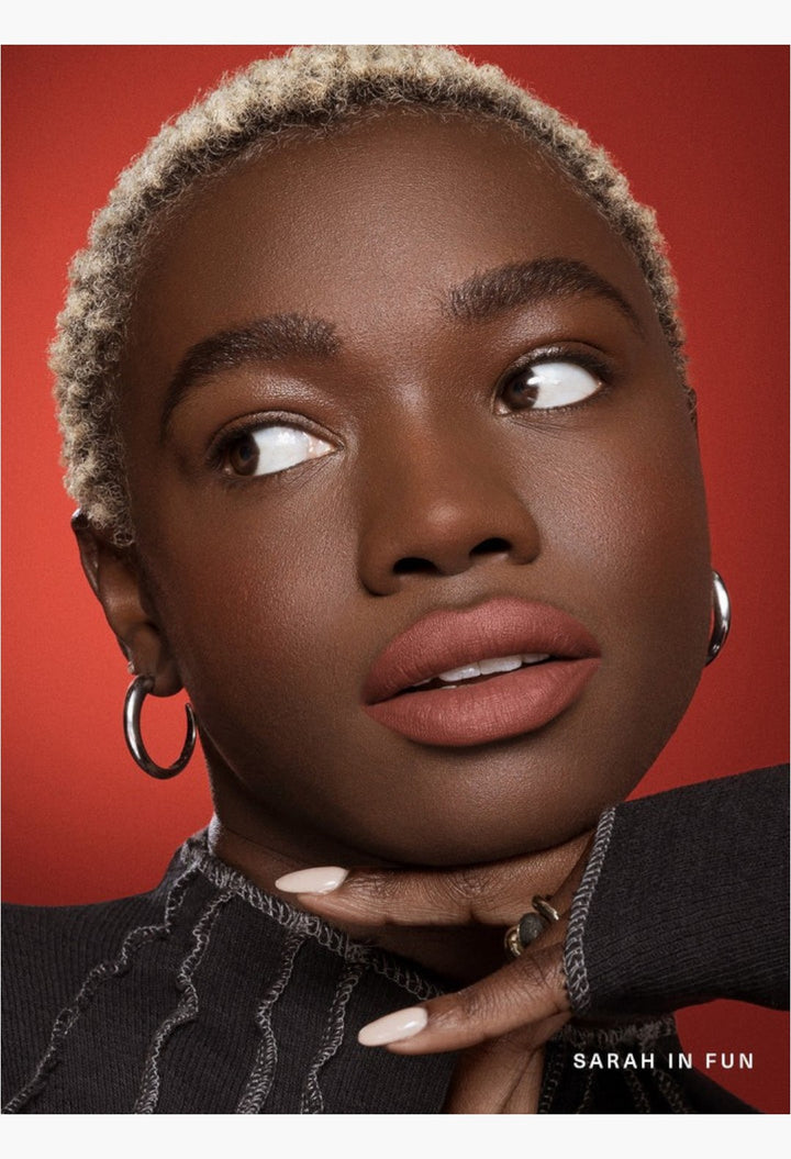 GLAM MODA Kind Words matte lip liner on a model with dark skin, showcasing a soft, muted mauve matte finish.