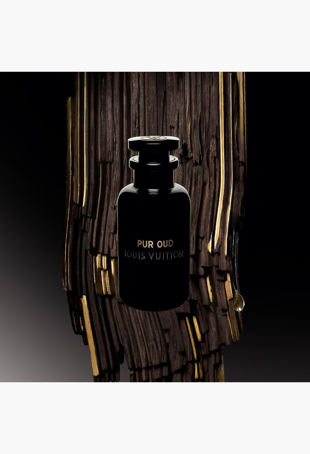 GLAM MODA Pur Oud perfume bottle in black glass with gold lettering, displayed against a textured dark wood background.