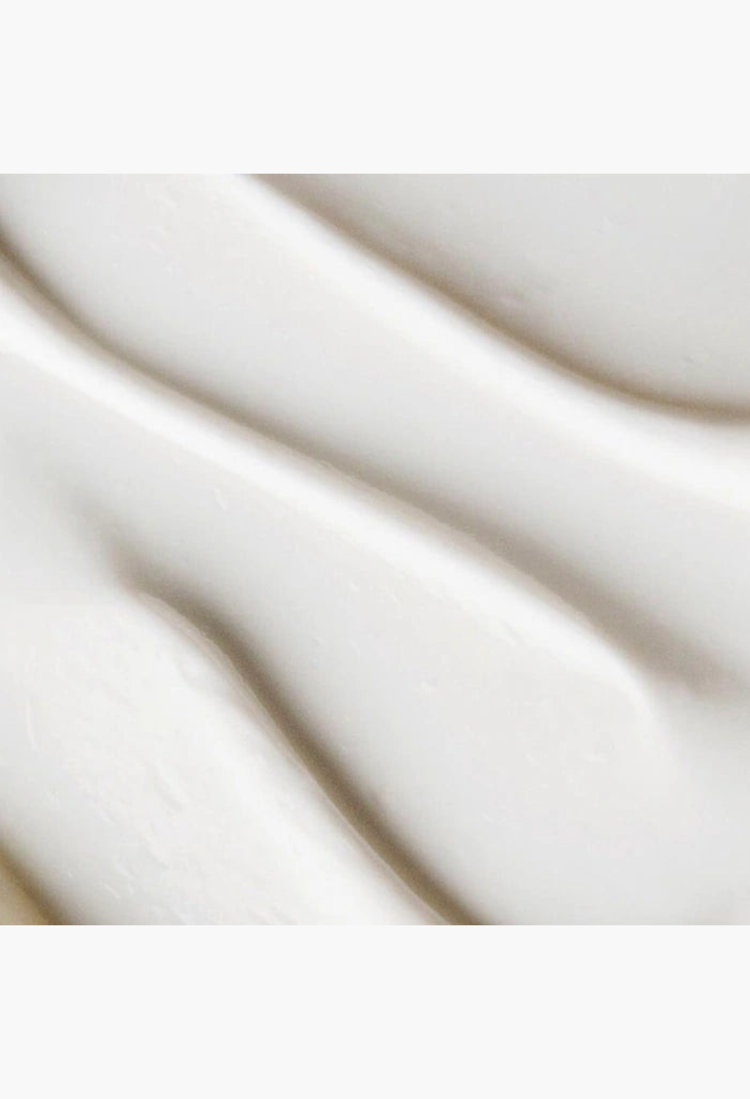 GLAM MODA goat milk moisturizing cream cleanser texture showing a smooth white non-foaming formula