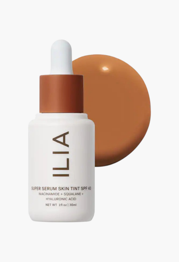GLAM MODA ILIA Super Serum Skin Tint SPF 40 bottle with a brown liquid foundation swatch on a white background