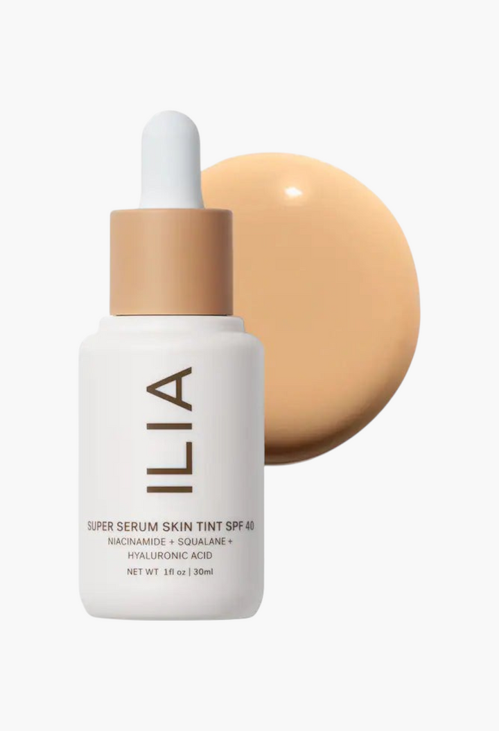 GLAM MODA ILIA Super Serum Skin Tint SPF 40 liquid foundation bottle with a swatch of light beige makeup