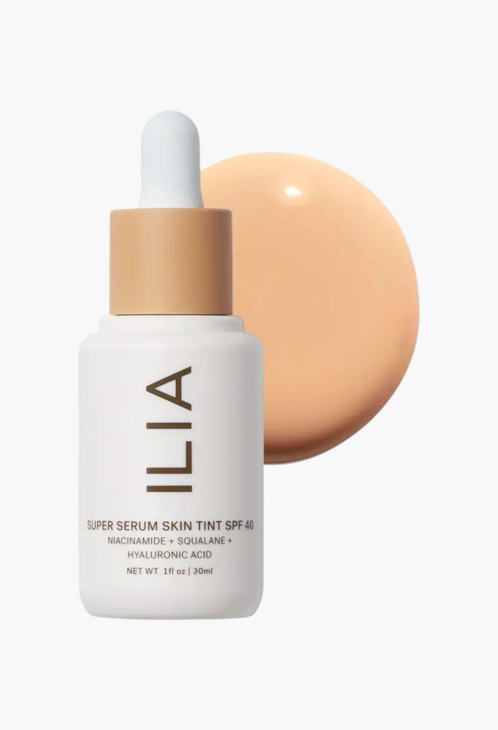 GLAM MODA ILIA Super Serum Skin Tint SPF 40 bottle with a swatch of liquid foundation on a white background.