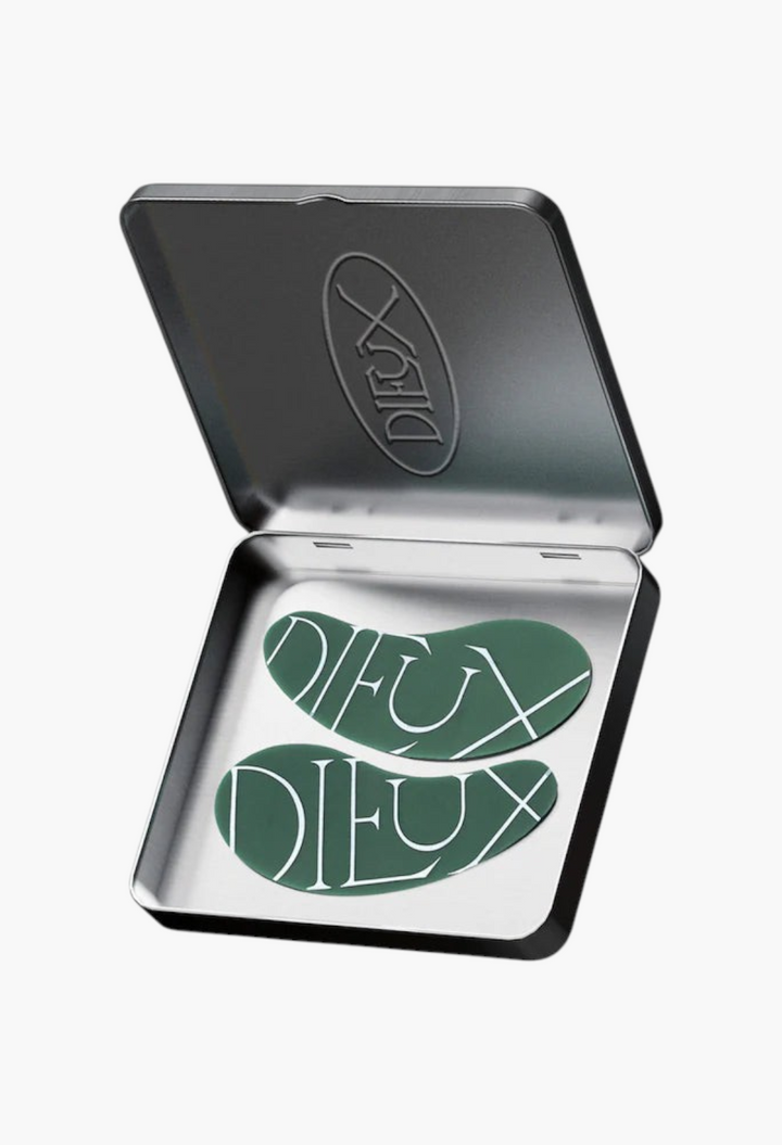GLAM MODA reusable green silicone eye patches inside a metal storage tin for targeted under-eye hydration.