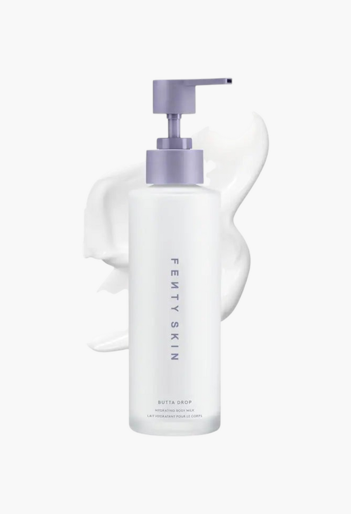 GLAM MODA Fenty Skin Butta Drop Hydrating Body Milk in a white bottle with a purple pump and creamy lotion texture.
