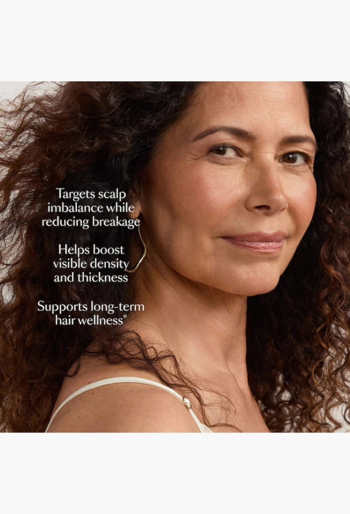 GLAM MODA model with healthy curly hair showcasing the benefits of the GRO+ Advanced Balancing hair care set.