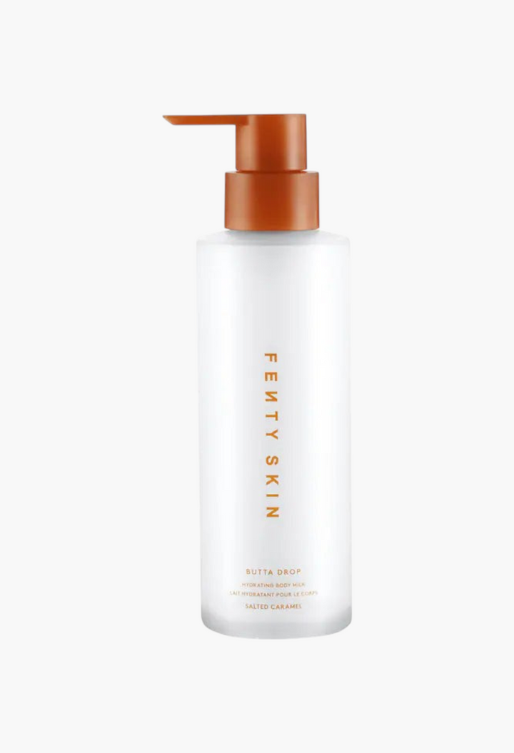 GLAM MODA Fenty Skin Butta Drop hydrating body milk in a clear pump bottle with a brown cap.