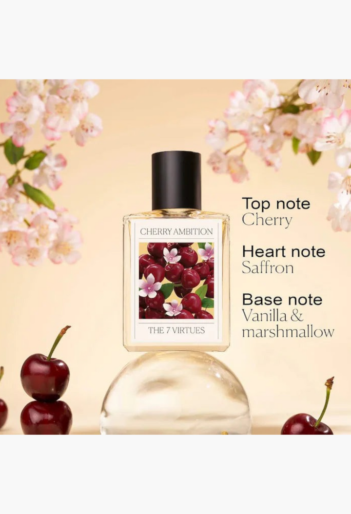 GLAM MODA The 7 Virtues Cherry Ambition perfume bottle with a cherry-themed label surrounded by fresh cherries