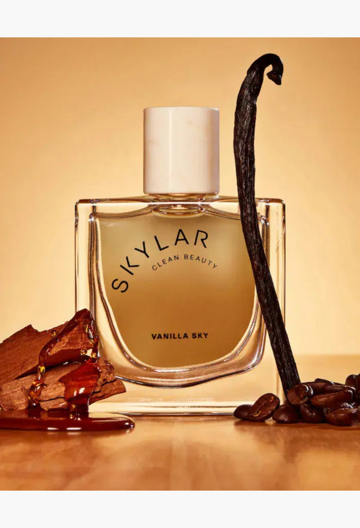 GLAM MODA Skylar Vanilla Sky perfume bottle with vanilla bean and coffee bean accents on a white background