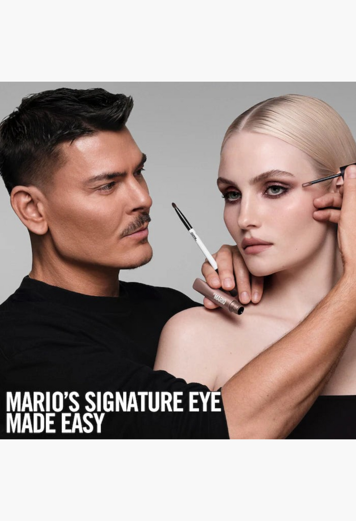 GLAM MODA makeup artist applying shimmer cream eyeshadow to a model using a brush for a professional eye look