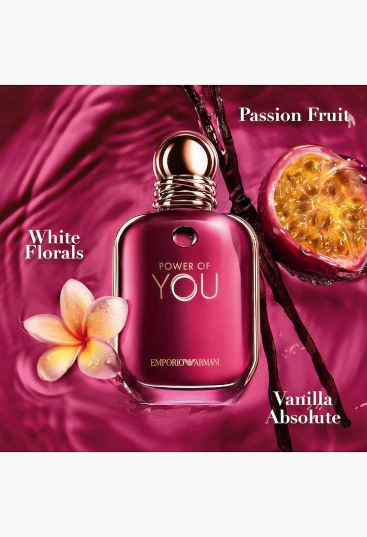 GLAM MODA Emporio Armani Power of You perfume bottle surrounded by passion fruit, white floral petals, and vanilla beans.