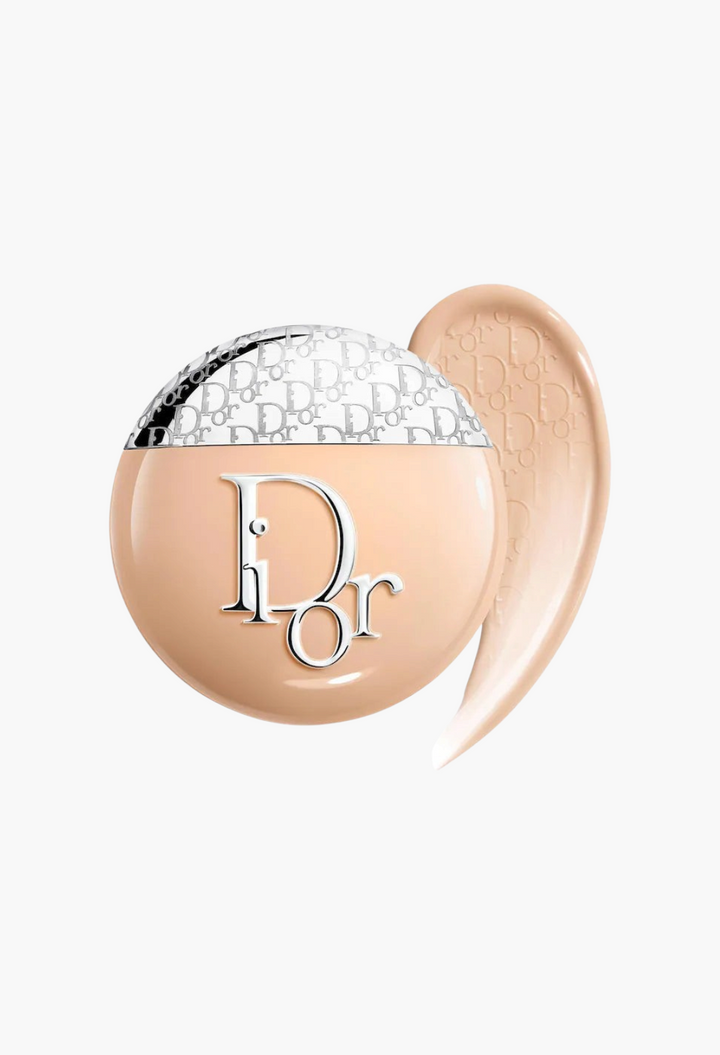 GLAM MODA Dior Backstage Glow-Up Skin Tint liquid moisturizer with SPF 20 in a round compact with a swatch of tint.