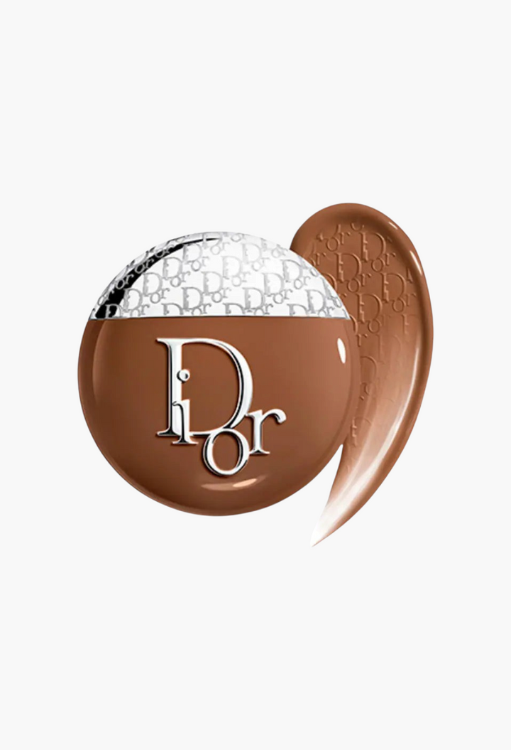 GLAM MODA Dior Backstage Glow-Up Skin Tint in a deep shade with a creamy liquid texture and silver cap detail.