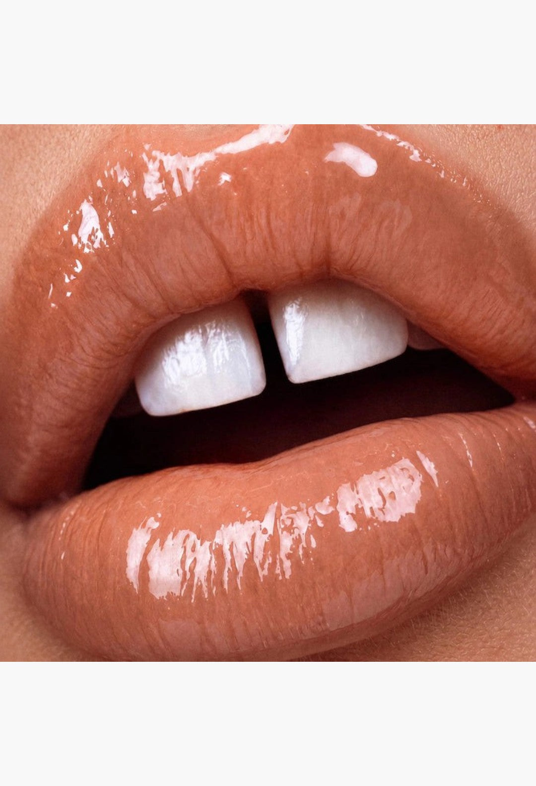 GLAM MODA Le Chouchou peptide lip balm applied to lips for a glossy, hydrated, and plump finish.
