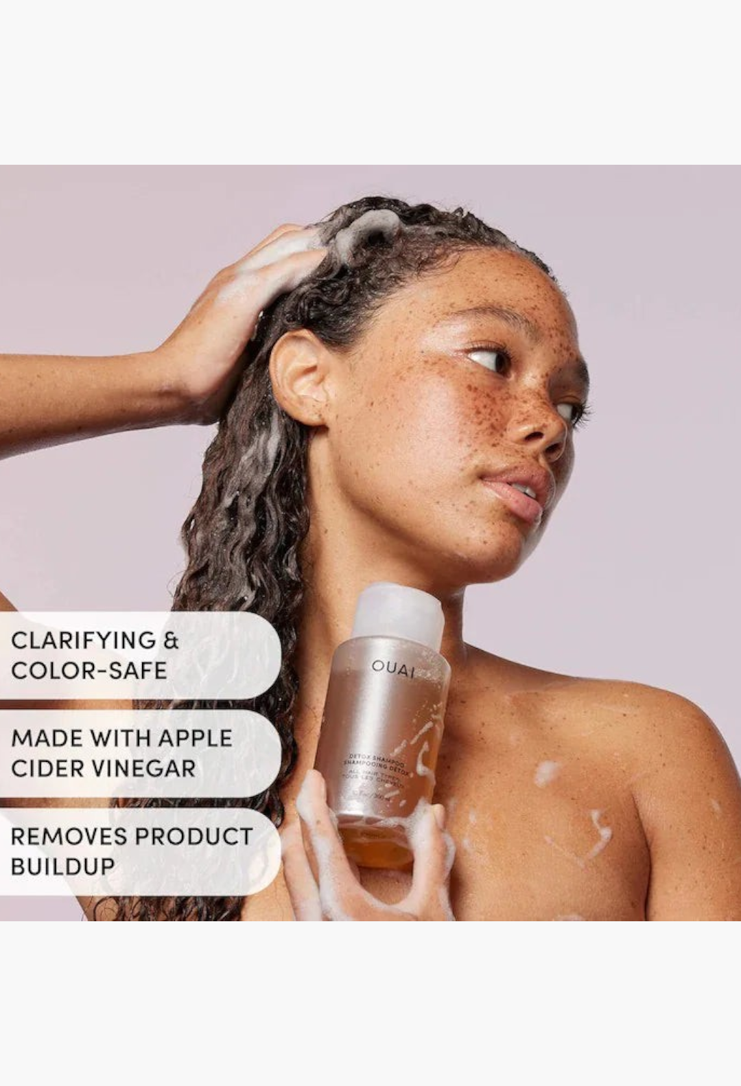 GLAM MODA model applying OUAI Detox Shampoo with apple cider vinegar to curly hair for clarifying and buildup removal