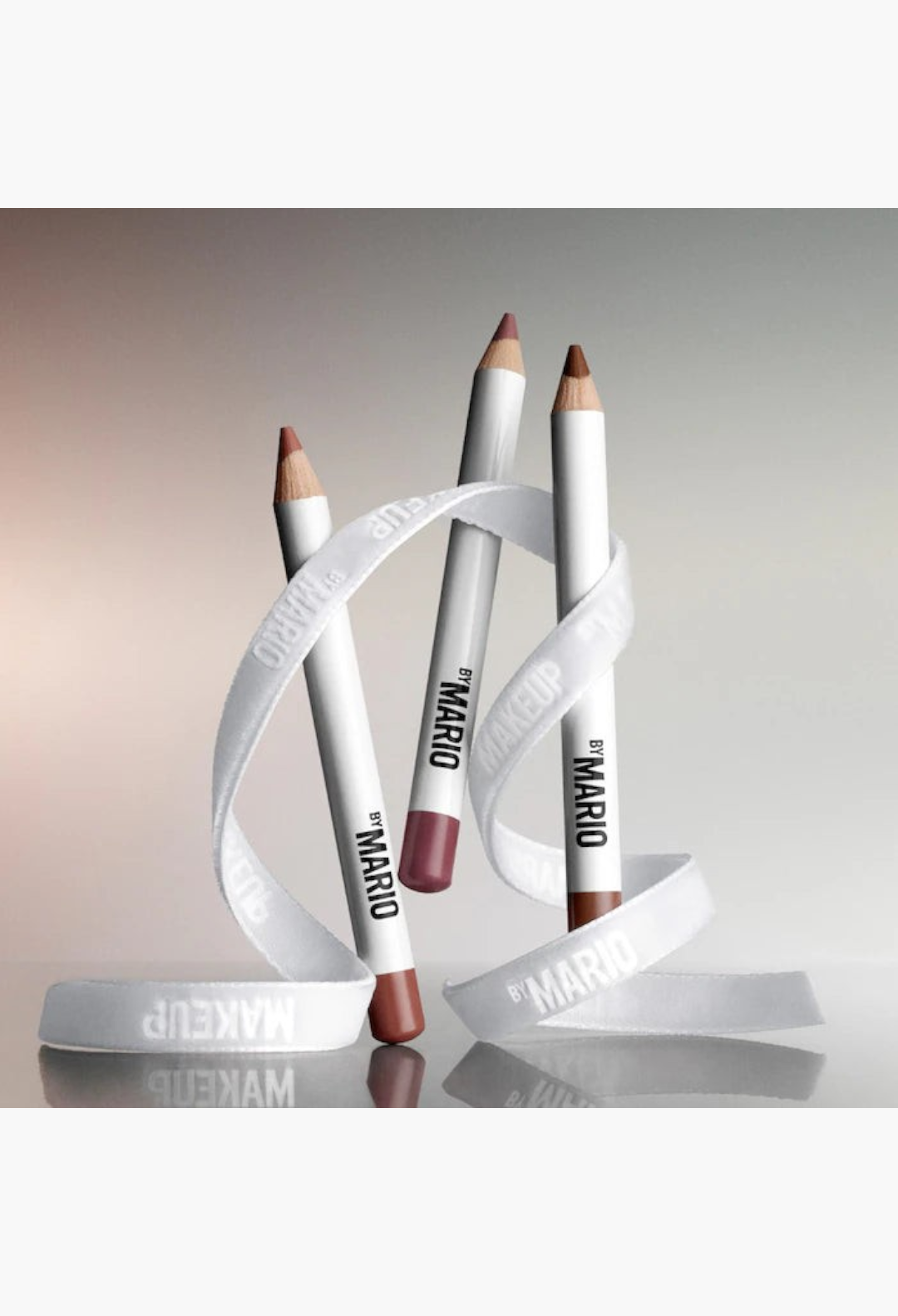 GLAM MODA trio of mini Ultra Suede sculpting lip pencils in neutral shades wrapped in a white branded ribbon.