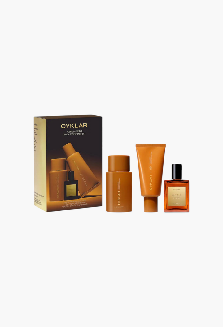 GLAM MODA Vanilla Verve body essentials gift set featuring body wash, body cream, and perfume oil in amber bottles.