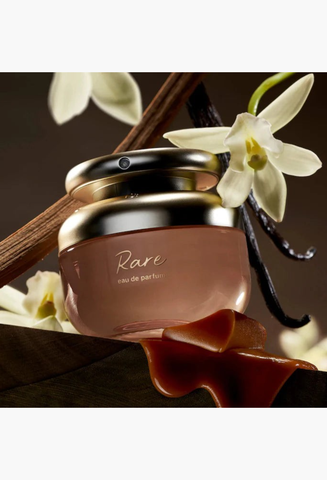 GLAM MODA Rare Beauty Rare Eau de Parfum bottle surrounded by vanilla bean and caramel accents.