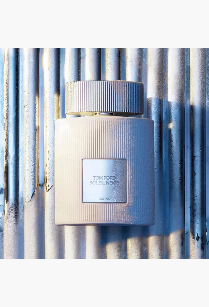 GLAM MODA Tom Ford Soleil Neige Eau de Parfum bottle with a textured white finish and silver cap.