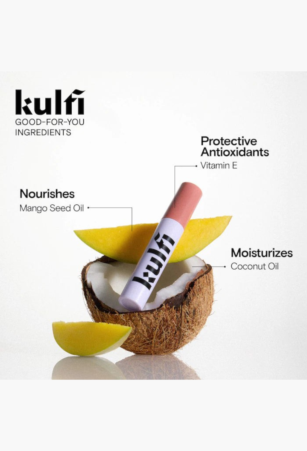 GLAM MODA Lassi Lips staining lip oil in a rosy shade, displayed with fresh mango slices and a coconut shell.
