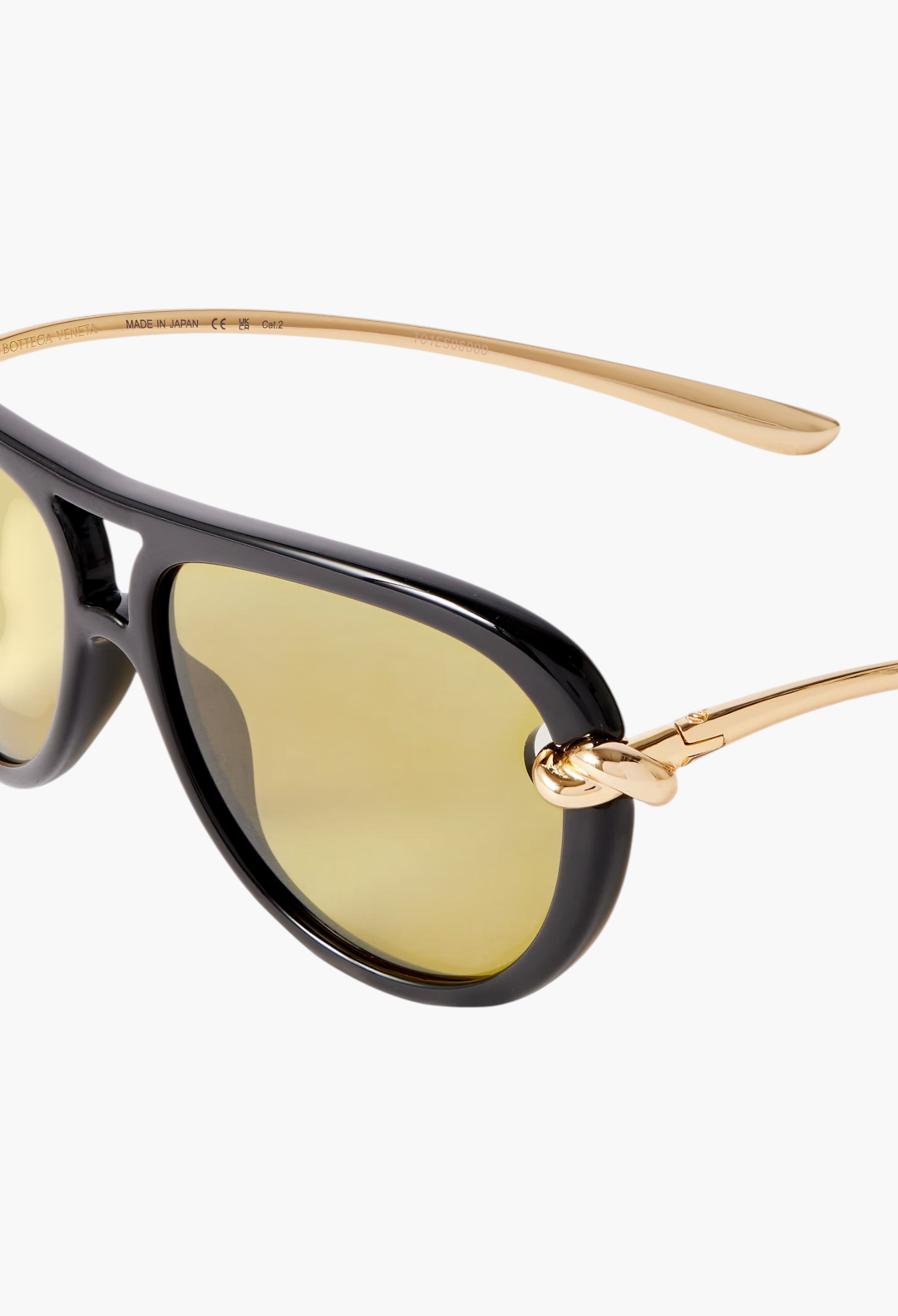 GLAM MODA New Knot aviator sunglasses featuring a black frame, gold-tone twisted metal temples, and transparent lenses.