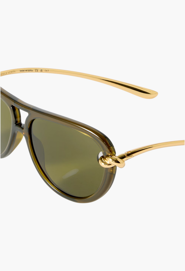 GLAM MODA Bottega Veneta New Knot aviator sunglasses featuring olive green frames and gold-tone twisted metal temples.