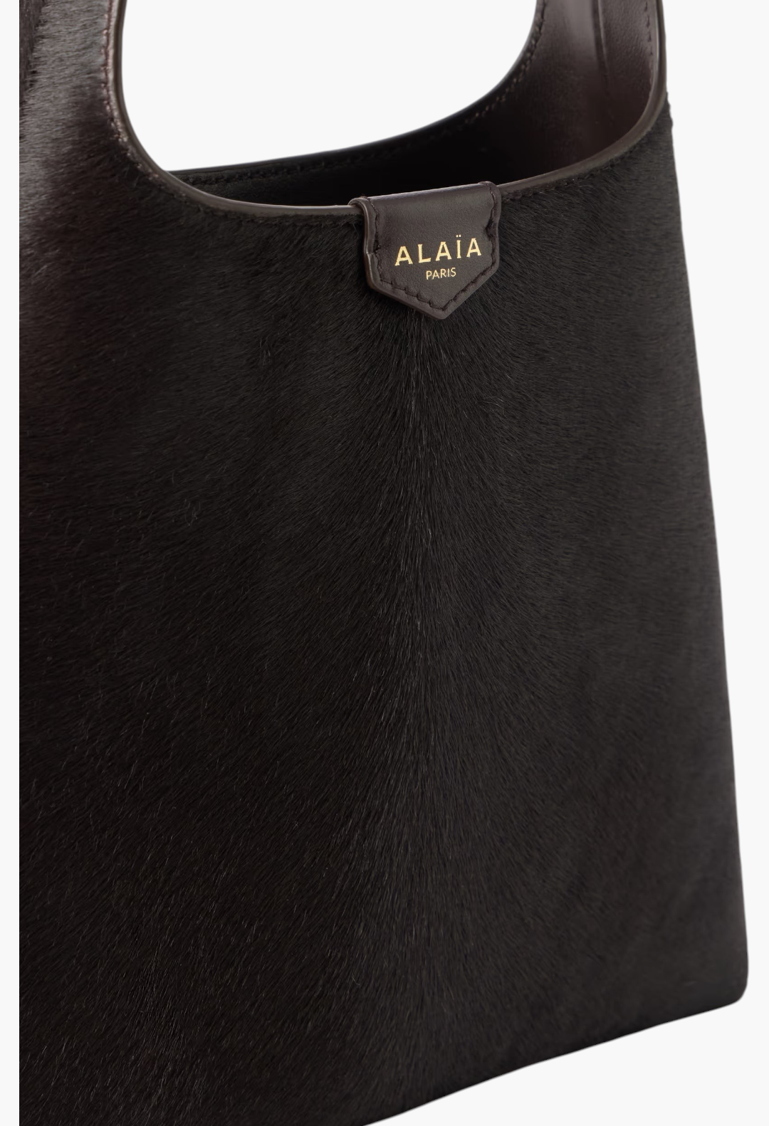 GLAM MODA Alaïa deep brown calf hair shoulder bag with a slouchy silhouette and leather shoulder strap